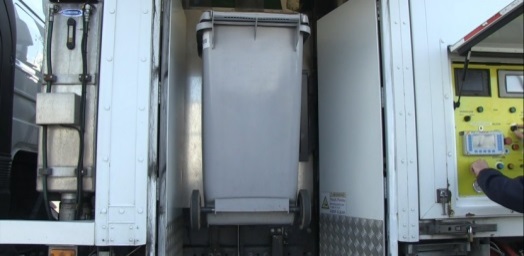 emptying receptacle in mobile shredding unit